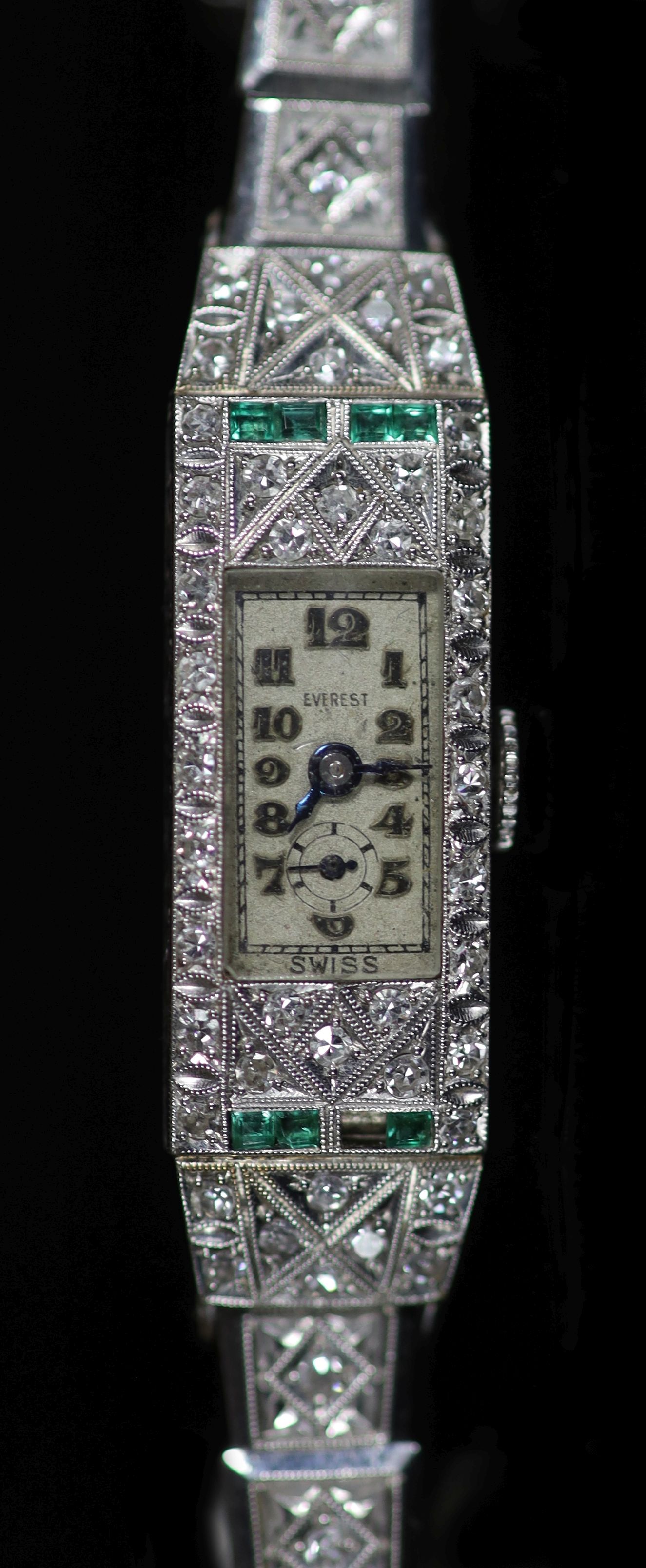 A lady's 1920's/1930's platinum, emerald and diamond set manual wind Everest cocktail watch